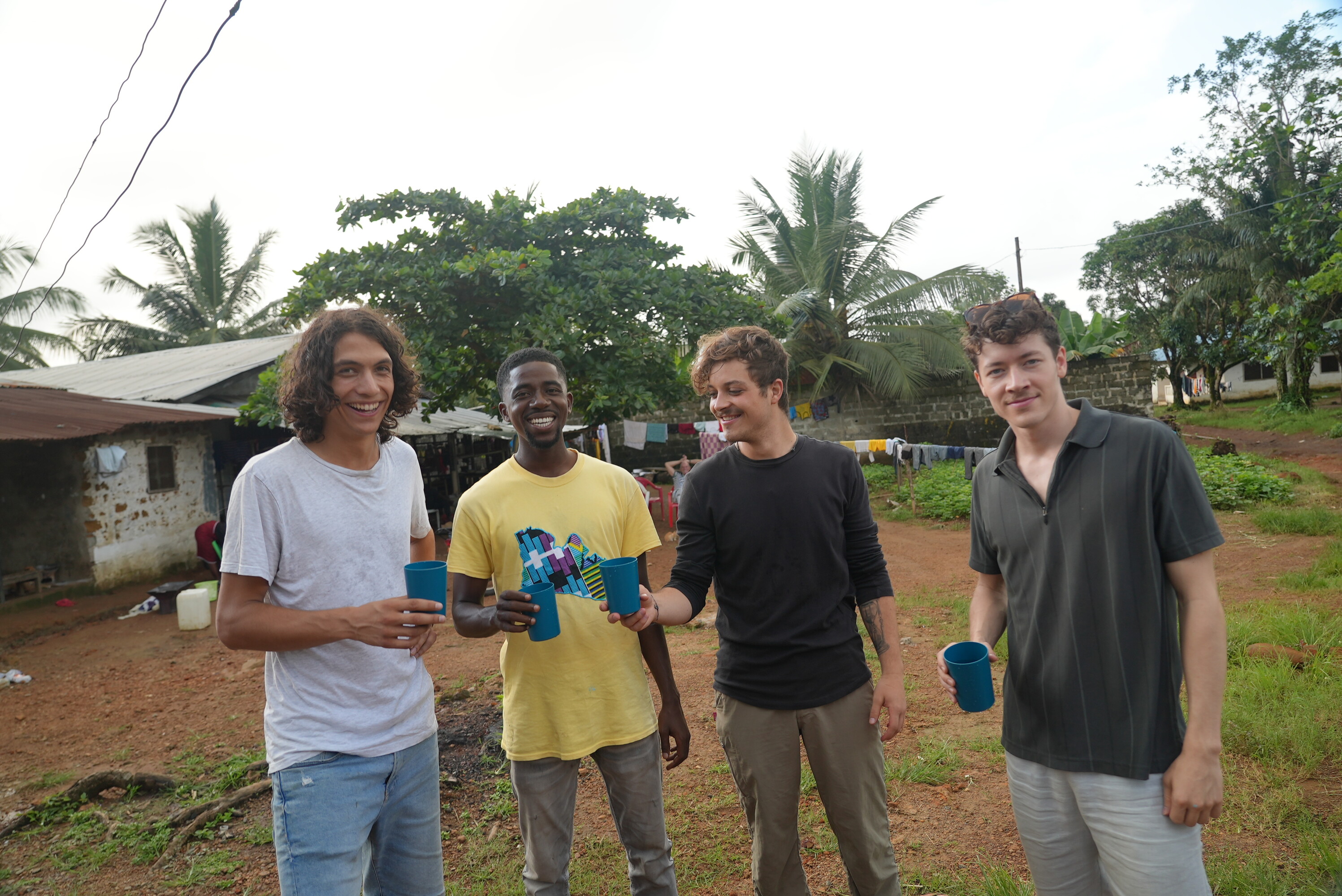 tudents from Switzerland and Liberia toast with a glass of water at the solar-powered water kiosk in Monrovia.