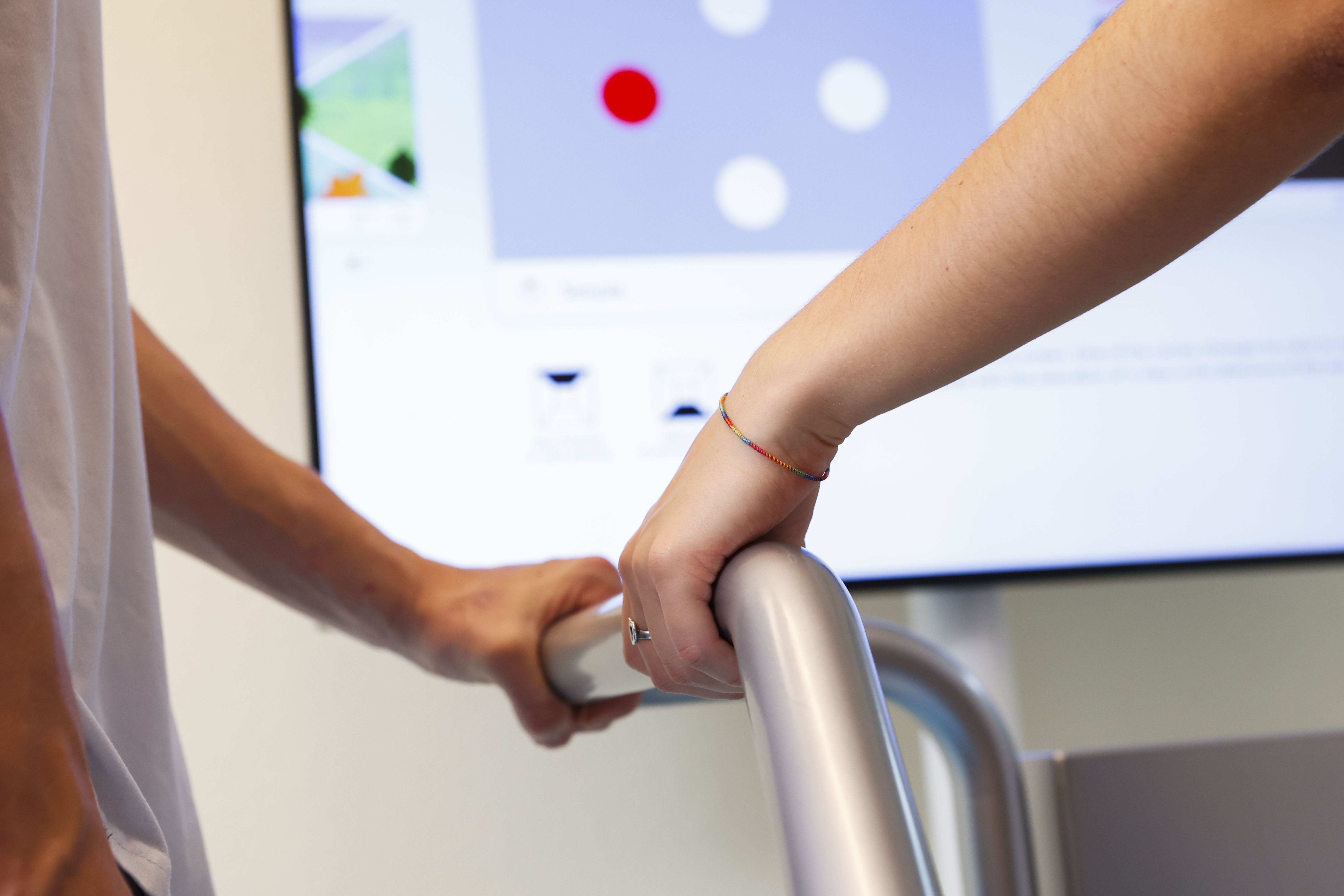 Zwei Hände auf einem Metallgeländer (Trainingsgerät Exergame in der Therapie von Dementia)